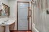 Hallway bath with locking exterior door onto the deck.