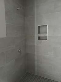 Great walk-in shower with floor-to-ceiling tile.