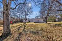 Another view from backyard toward the back of the house and the detached garages.