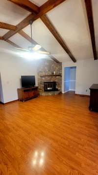 Nice stone gas fireplace in family open area.