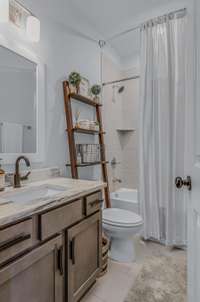 Full bathroom is on the main level and has tile surround.