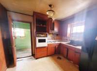 The Kitchen has a window at the sink for gazing into into the spacious back yard. There is also a door leading to the garage.