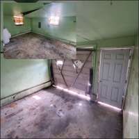 Two views in one of the garage space. It has two windows and washer and dryer connection.