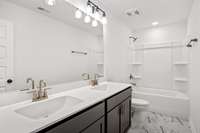 The upstairs secondary bathroom also features dual sinks.