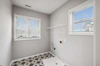 Tiled Laundry located at the top of the stairs. Beautiful natural light in this room!