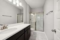 Primary bath to include a Walk-in Shower, Tile Flooring & Quartz Countertops.