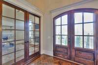 Gorgeous solid wood double doors, herringbone floor detail and a glass-paned door leading to the office immediately capture attention and is just the beginning of the features that this home has to offer!