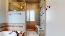 Large shower with heated floor and bench seat