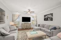 Large living room with crown molding and hardwood flooring.