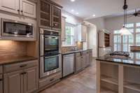 Granite countertops and tons of cabinets for storage.