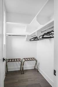 As if it weren't enough, the primary suite also includes a sizeable walk-in closet to maintain all of your guests' personal effects. Built in shelving adds convenience and functionality, and is ideal for storing extra linens for easy access.