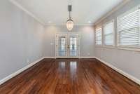 Adjacent to the kitchen, a large open area leading out to the back deck