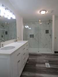 Wow what a Master Bath !!!! New walk in tile shower and Double sinks in the large vanity! Counter top is a solid surface. All new lighting, counter top, Faults commode ,There is 2 closets in this bathroom!