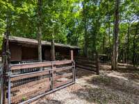 Horse shed next to holding pen for livestock