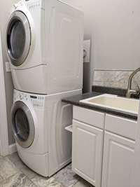 Laundry with pantry just off the main living and kitchen area