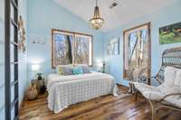 Delightful guest bedroom with ample natural light & country views.