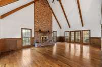 Interior living room of guest house invites with its vaulted ceiling and cozy fireplace.