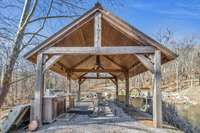 Timber framed pavilion beside the pond, with grill and sitting area perfect for enjoying with friends.