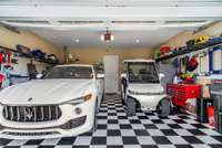 There’s even a squeaky clean two car garage with custom flooring.