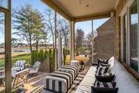 Heading to the outdoor oasis, first you come to a wonderful screened in porch just off the living area and overlooking the golf course.