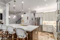 Notice the custom cabinet lighting and abundance of countertop space.