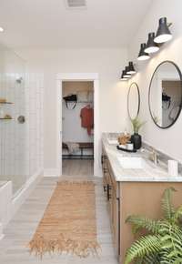 Separate shower /tub in owners bath with double vanities! Different options of bathroom layout to choose from. Photo not of actual home.