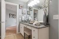 Granite counters and a vanity area make this bathroom extra special.