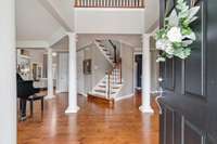 The grand two story foyer is flanked by a music room and a dining room.