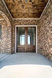 Gorgeous double front doors with glass to allow for plenty of light. Check out the tongue and groove ceiling with custom stain.