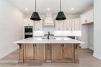 Large island w/quartz counter tops. We don't wast any space, look at the storage in that island!