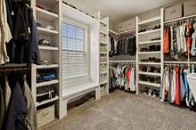 HUGE Walk In Closet In Primary Bedroom With Custom Wood Built In's