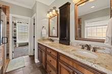 Primary Bath With Double Granite Vanities And Tile Flooring