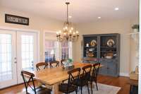 Gathering Room off kitchen with French doors leading to screened in porch.