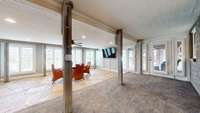 Downstiars Sunroom/ Game Room with stone flooring.  Beautiful lake views from the wall of windows.