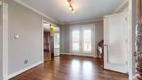 Flex space with entrance to outside decking.  Laundry room is on the left behind the mirrored doors.