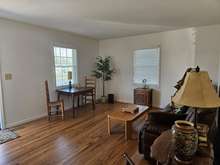 THE LIVING AREA WITH LOVELY FLOORING AND FRESH PAINT PLUS LOTS OF NATURAL LIGHTING....