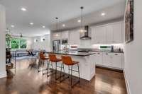 Open light-filled kitchen with modern pendant lighting and generous recessed lights throughout this home.