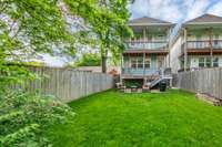 Fully Fenced level backyard with lush green grass.