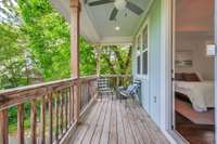 From the Primary Suite, walk out onto the private 2nd Story Covered Deck that sits among the treetops.