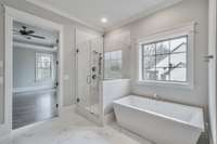 Freestanding Soaking Tub & Frameless Shower Enclosure in Primary Bath.