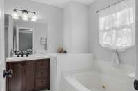 Well appointed master bathroom has a separate shower and tub.