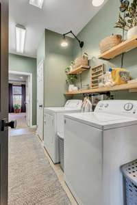 The laundry room has lots of storage space and leads to the oversized 3 car garage.