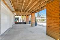 below the deck is the covered entry to the 2 car garage with 2 separate garage doors