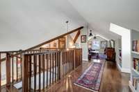 At the top of the stairs, built in bookshelves line the walls