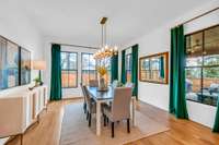 Light Filled Dining Room with Dramatic Custom Lined Draperies with Brass Rods