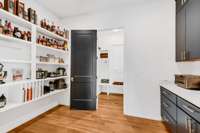 Spacious Walk Through Working Pantry and (12' x 7') with Built-in Shelving and Coordinating Cabinets/Counters