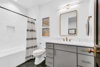 En Suite Bathroom with Shower/Tub Combo, Tiled Surround, and Quartz Countertop