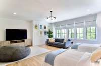 The light filled 5th Bedroom features Custom Roman Blinds and Blackout Shades.