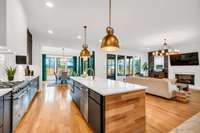 Light-filled view across the 10 ft Marble Island towards the Covered Back Porch and Fenced Backyard.