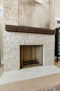 Wood burning fireplace with gas starter finished off with traditional stone to the ceiling and limestone hearth